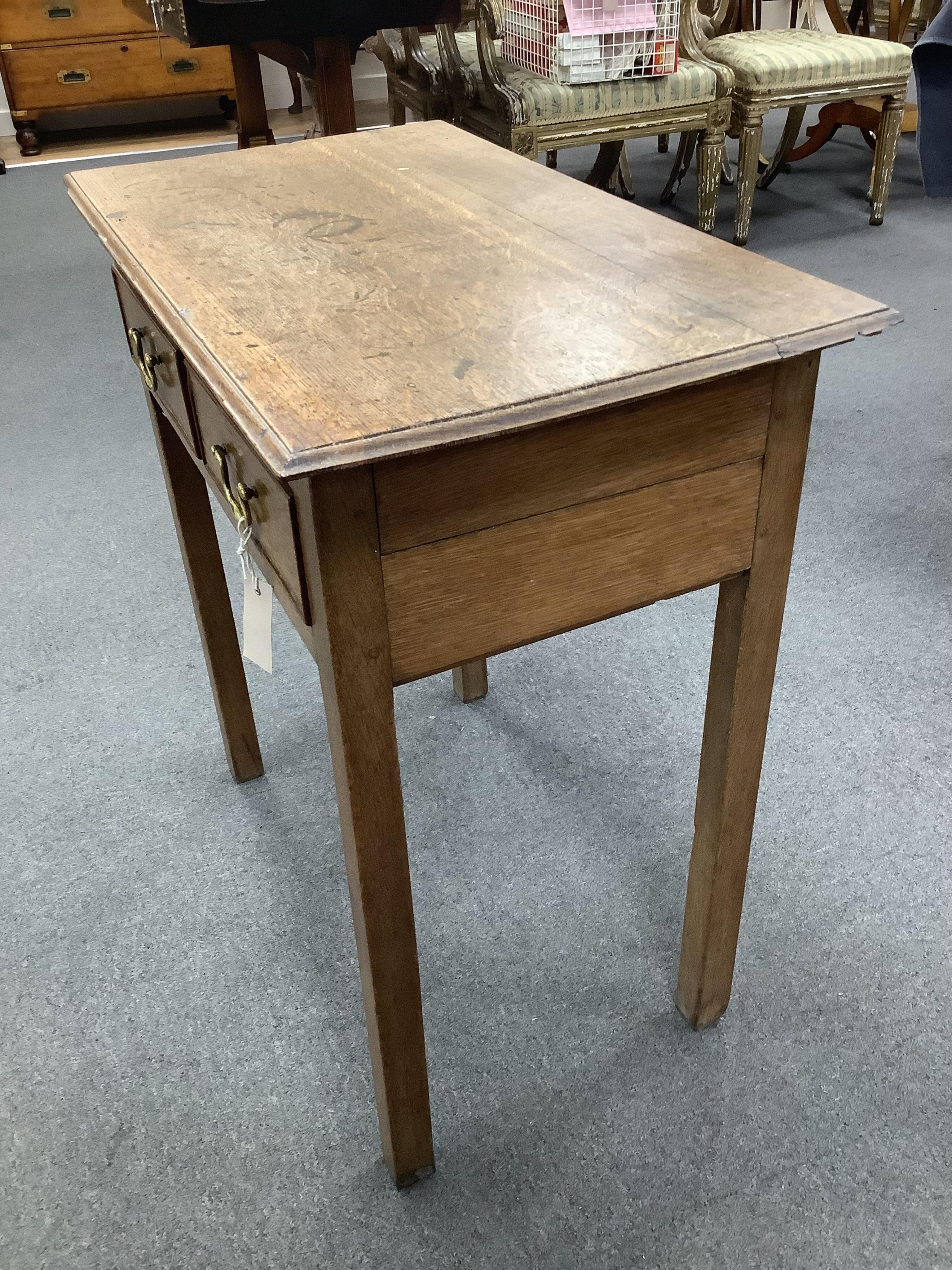 A small 18th century oak two drawer side table, width 69cm, depth 39cm, height 70cm. Condition - poor to fair